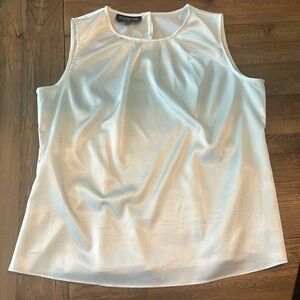 Cream colored shell. Perfect with suits. Silky fabric.